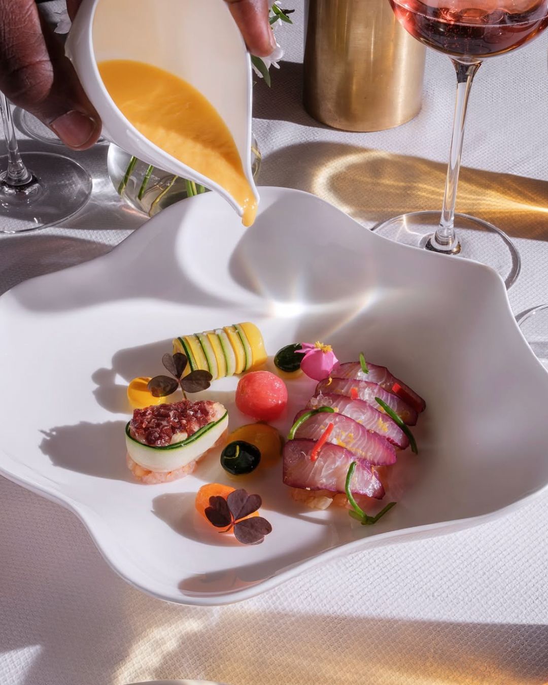 Elegant dish featuring colorful garnishes and sauces, highlighting fine dining at Le Pavillon.